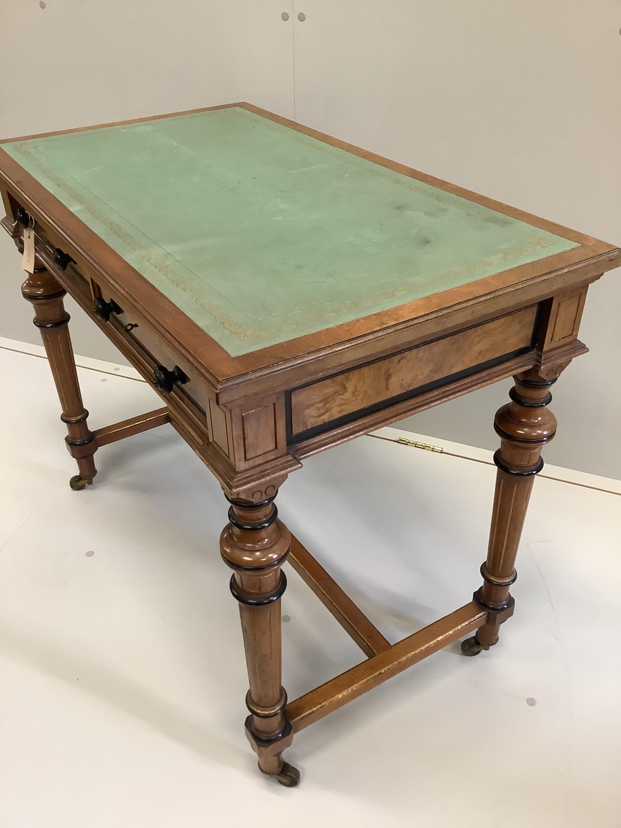A Victorian Gillows walnut and part ebonised two drawer writing table, width 91cm, depth 53cm, height 75cm